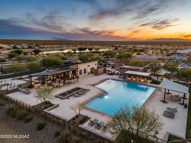 pool at dusk with a patio