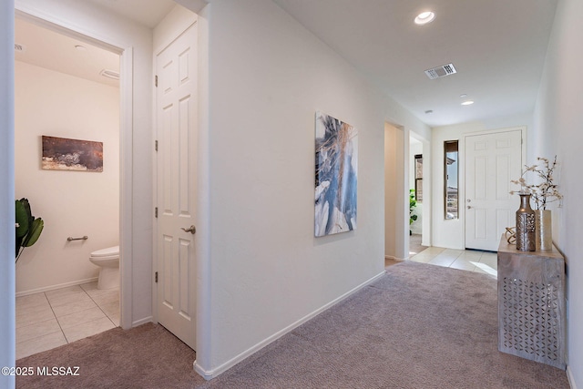 hall with recessed lighting, visible vents, carpet flooring, baseboards, and tile patterned floors