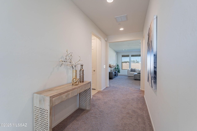 hall with recessed lighting, carpet flooring, visible vents, and baseboards