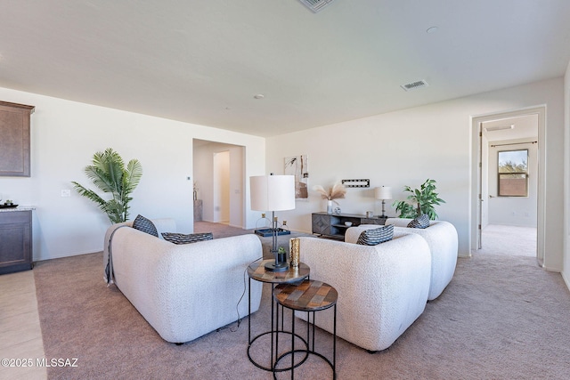 living room featuring light colored carpet and visible vents