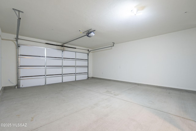 garage with a garage door opener and baseboards