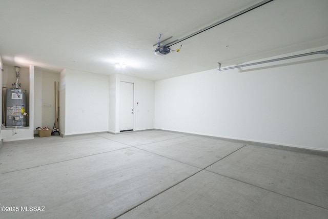 garage featuring a garage door opener, water heater, and baseboards