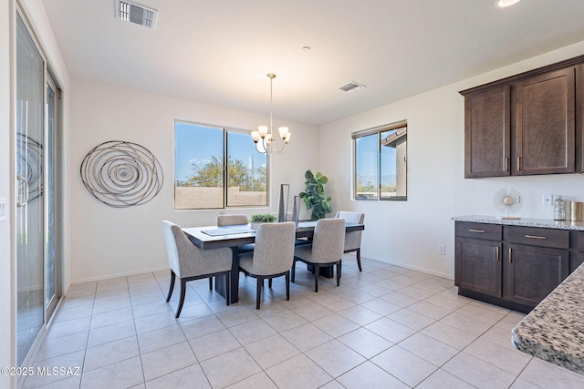 dining room featuring a chandelier, visible vents, and baseboards