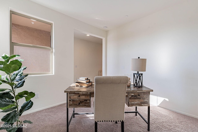 carpeted office space featuring baseboards