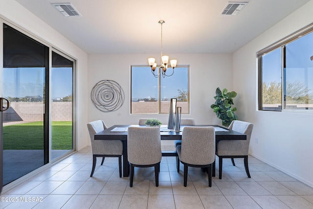 dining room with an inviting chandelier, baseboards, visible vents, and light tile patterned flooring