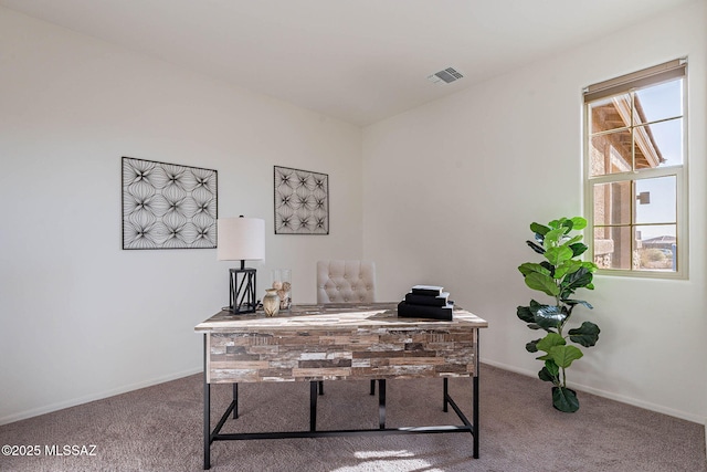 office area featuring visible vents, baseboards, and carpet flooring