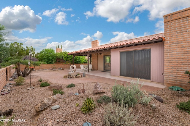 back of property with a patio