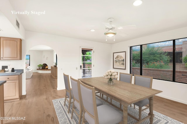 dining space with ceiling fan and light hardwood / wood-style floors