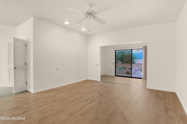 unfurnished room with light hardwood / wood-style flooring and ceiling fan