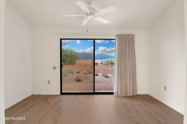 unfurnished room with light wood-type flooring and ceiling fan