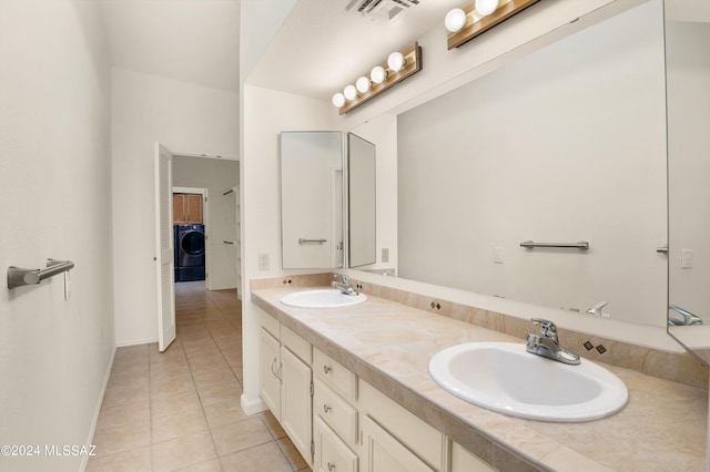 bathroom featuring tile patterned flooring, washer / dryer, and vanity