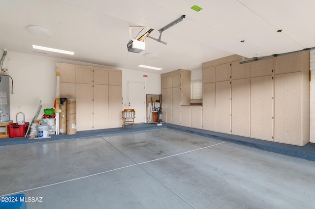 garage with electric water heater and a garage door opener