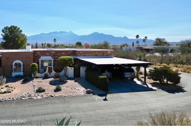 view of front of property with a carport and a mountain view