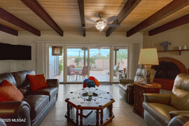 tiled living room featuring ceiling fan, wood ceiling, and beamed ceiling