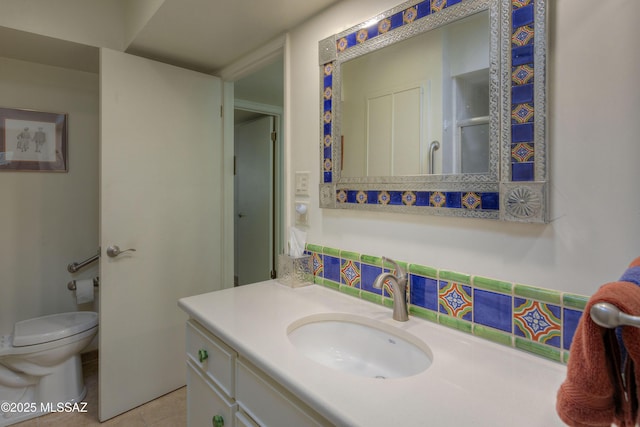 bathroom with vanity, toilet, and tile patterned flooring