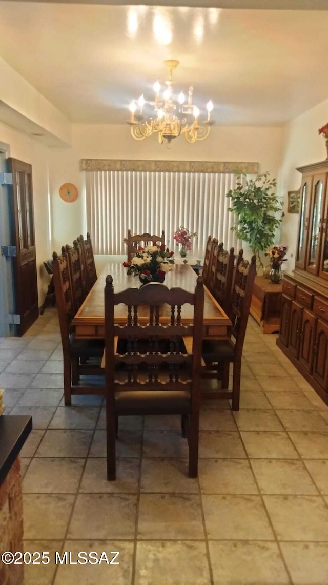 dining room with light tile patterned flooring and an inviting chandelier