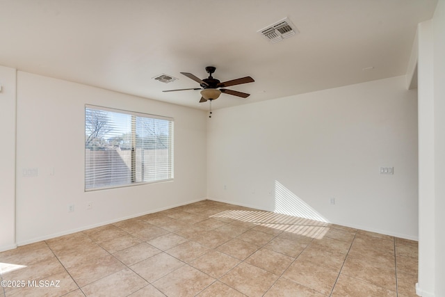 tiled empty room with ceiling fan