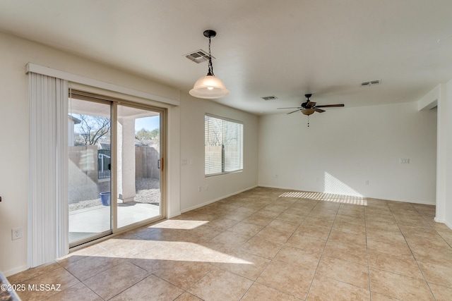 tiled spare room with ceiling fan