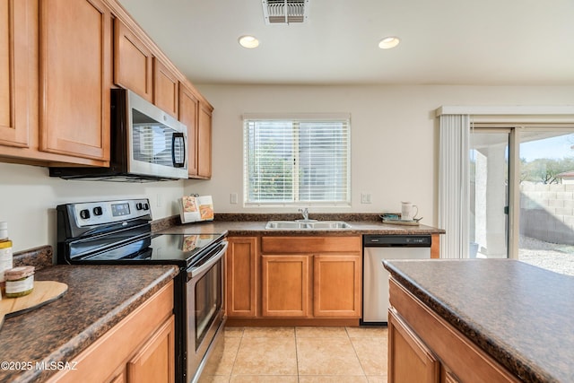 kitchen featuring light tile patterned floors, sink, and appliances with stainless steel finishes