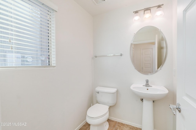 bathroom with tile patterned floors and toilet