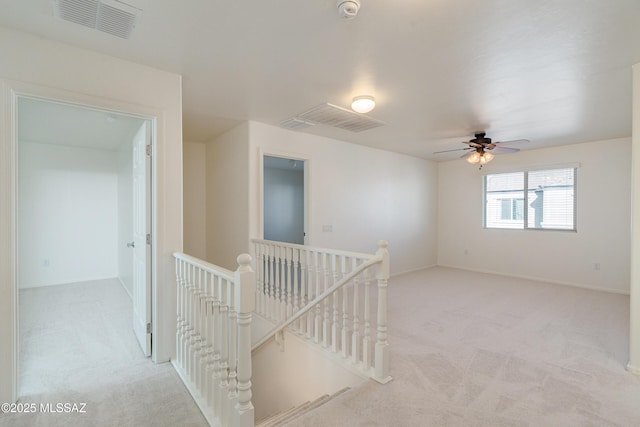 hallway with light colored carpet