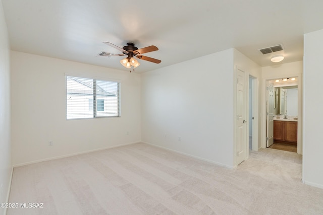 carpeted spare room with ceiling fan