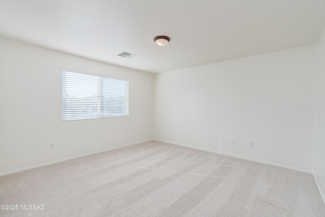 empty room featuring light carpet