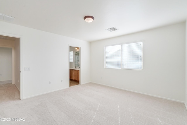 empty room featuring light carpet