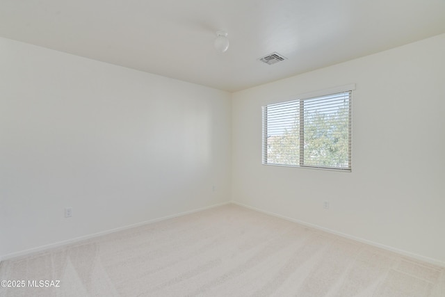 spare room with light colored carpet