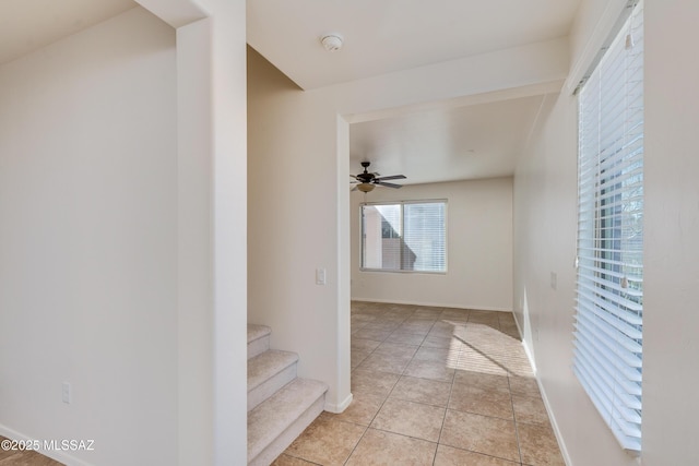 corridor featuring light tile patterned floors