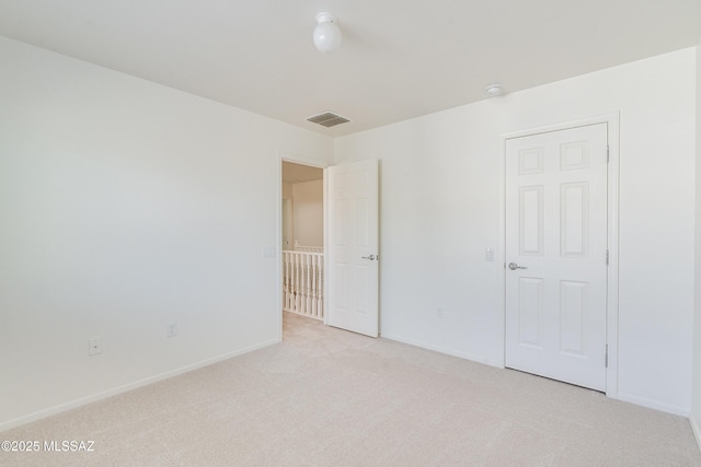 unfurnished bedroom featuring light colored carpet