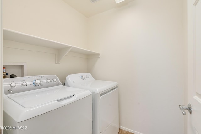 washroom featuring washer and clothes dryer