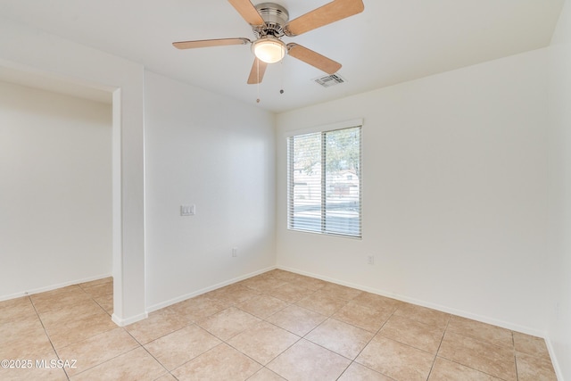 unfurnished room with ceiling fan and light tile patterned flooring