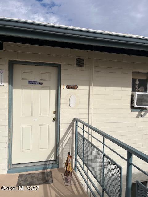 entrance to property featuring cooling unit