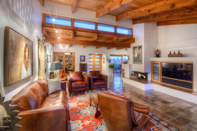 living room with beamed ceiling, a high ceiling, and wooden ceiling