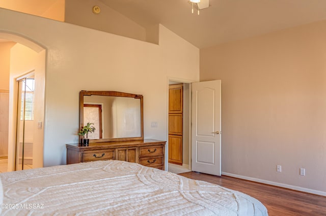 bedroom with light hardwood / wood-style floors, ceiling fan, and lofted ceiling