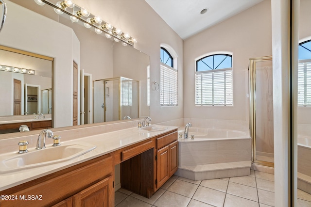 bathroom featuring tile patterned flooring, vanity, independent shower and bath, and lofted ceiling