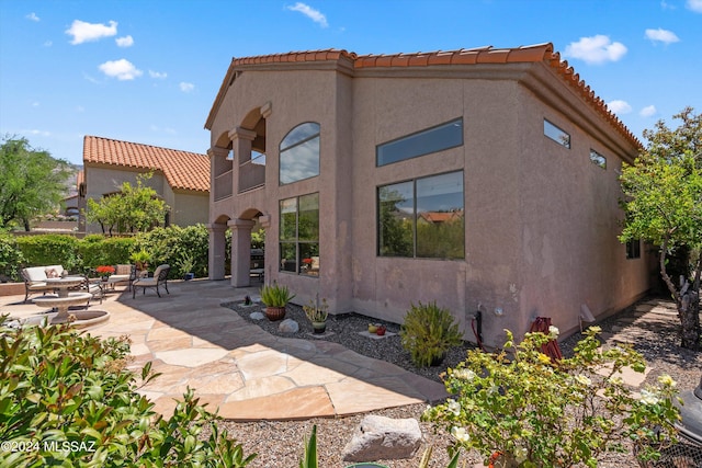 back of property featuring a patio