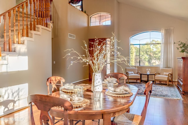 dining area featuring lofted ceiling and wood-type flooring