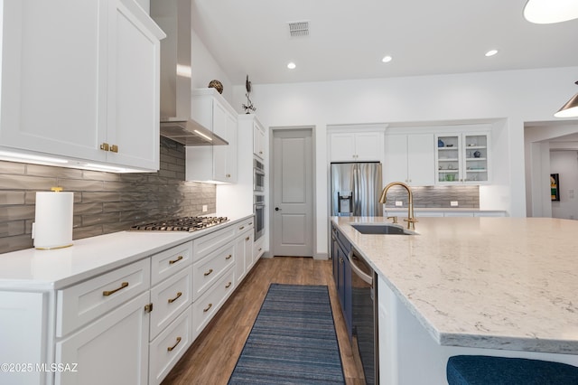 kitchen with wine cooler, wall chimney exhaust hood, sink, and white cabinets