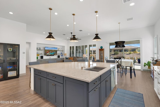 kitchen featuring dishwasher, white cabinetry, sink, gray cabinetry, and light stone counters