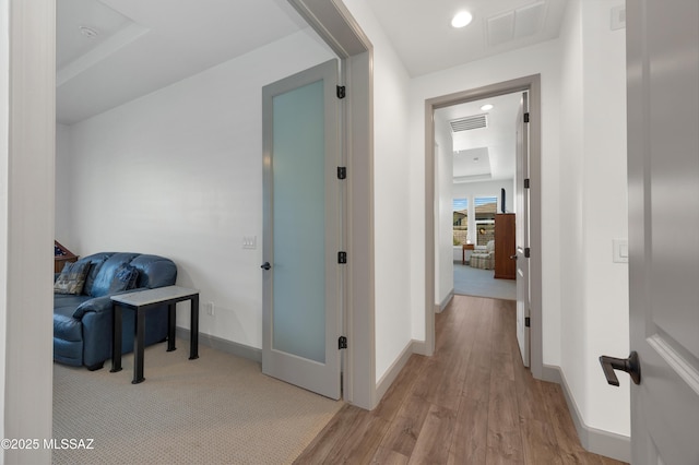 hallway with light hardwood / wood-style flooring