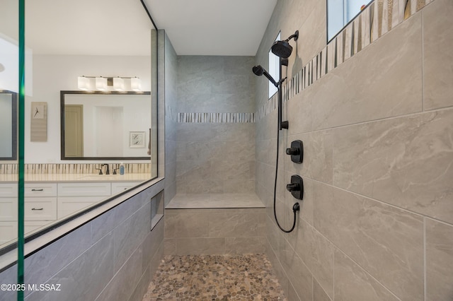 bathroom featuring vanity and a tile shower