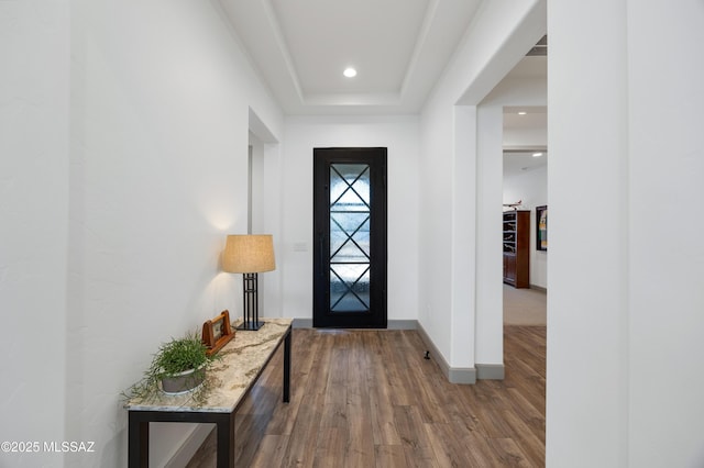 entrance foyer featuring hardwood / wood-style floors and a tray ceiling