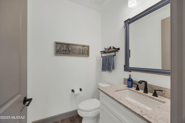 bathroom with vanity, wood-type flooring, and toilet