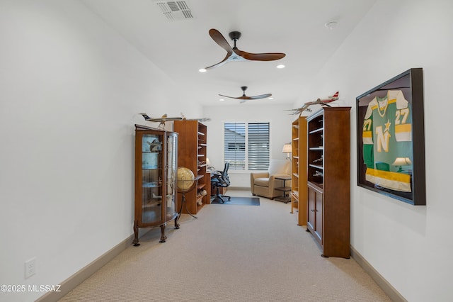 interior space featuring ceiling fan and light carpet