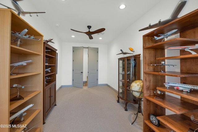 home office featuring light colored carpet and ceiling fan