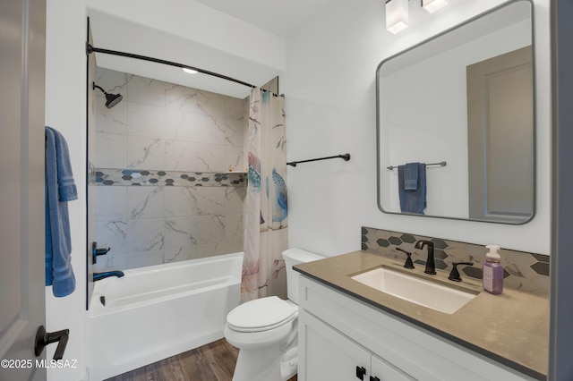 full bathroom with tasteful backsplash, shower / bath combination with curtain, hardwood / wood-style flooring, vanity, and toilet