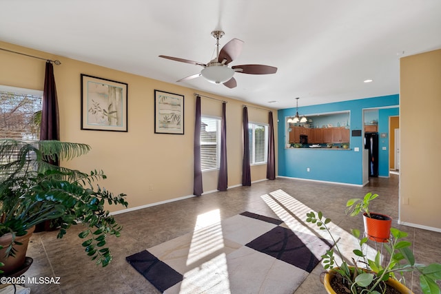 tiled living room featuring ceiling fan with notable chandelier