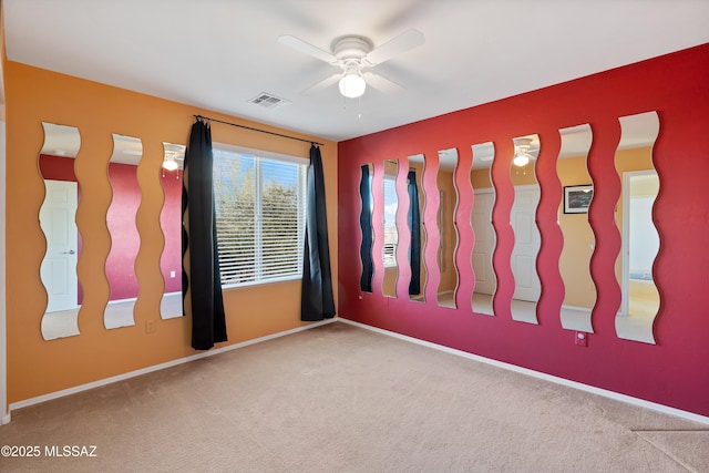 carpeted empty room featuring ceiling fan